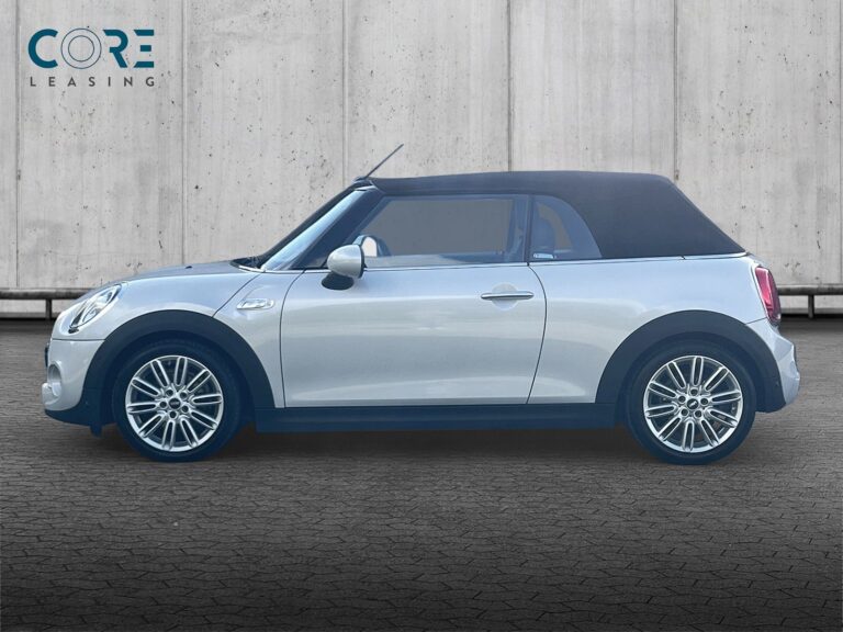 Sølvmetal MINI Cooper S Excitement Cabriolet aut. fra 2019 parkeret foran en betonmur. CORE Leasing A/S er eksperter i MINI leasing.